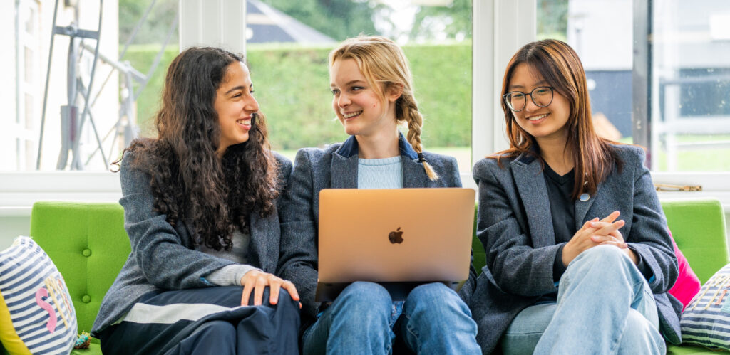 Girls chatting with laptop at Badminton School