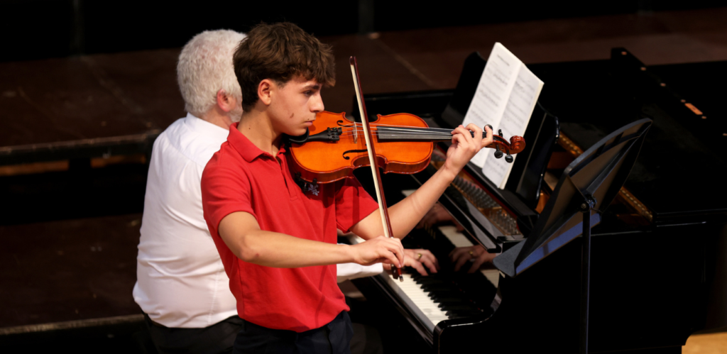 Boy placing the violin at Westbourne