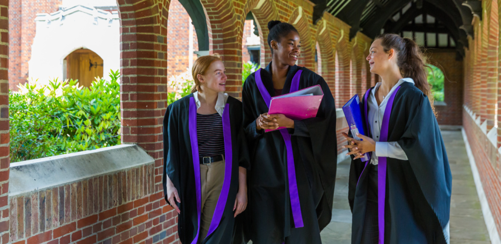 Queenswood pupils walking around the school chatting after a ceremony.